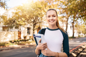 girl holding books at college